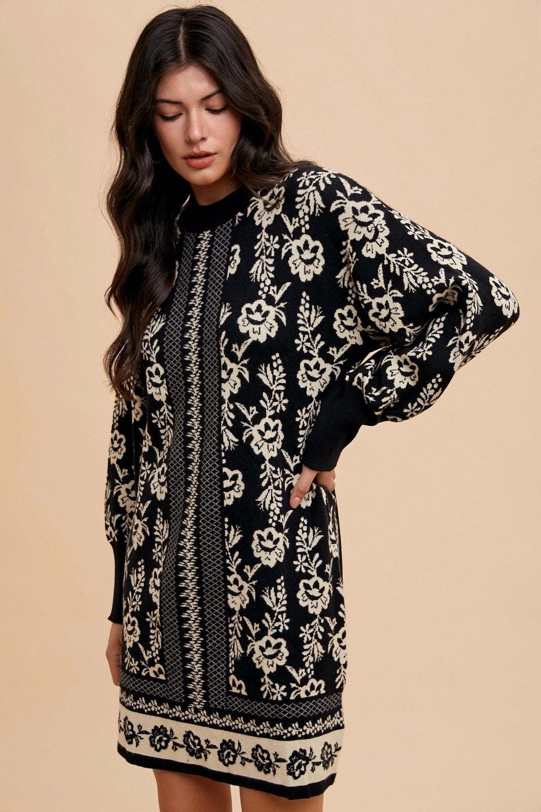 Woman wearing Faith Floral Jacquard Round Neck Sweater Dress with black and white floral pattern, slightly stretchy fabric.