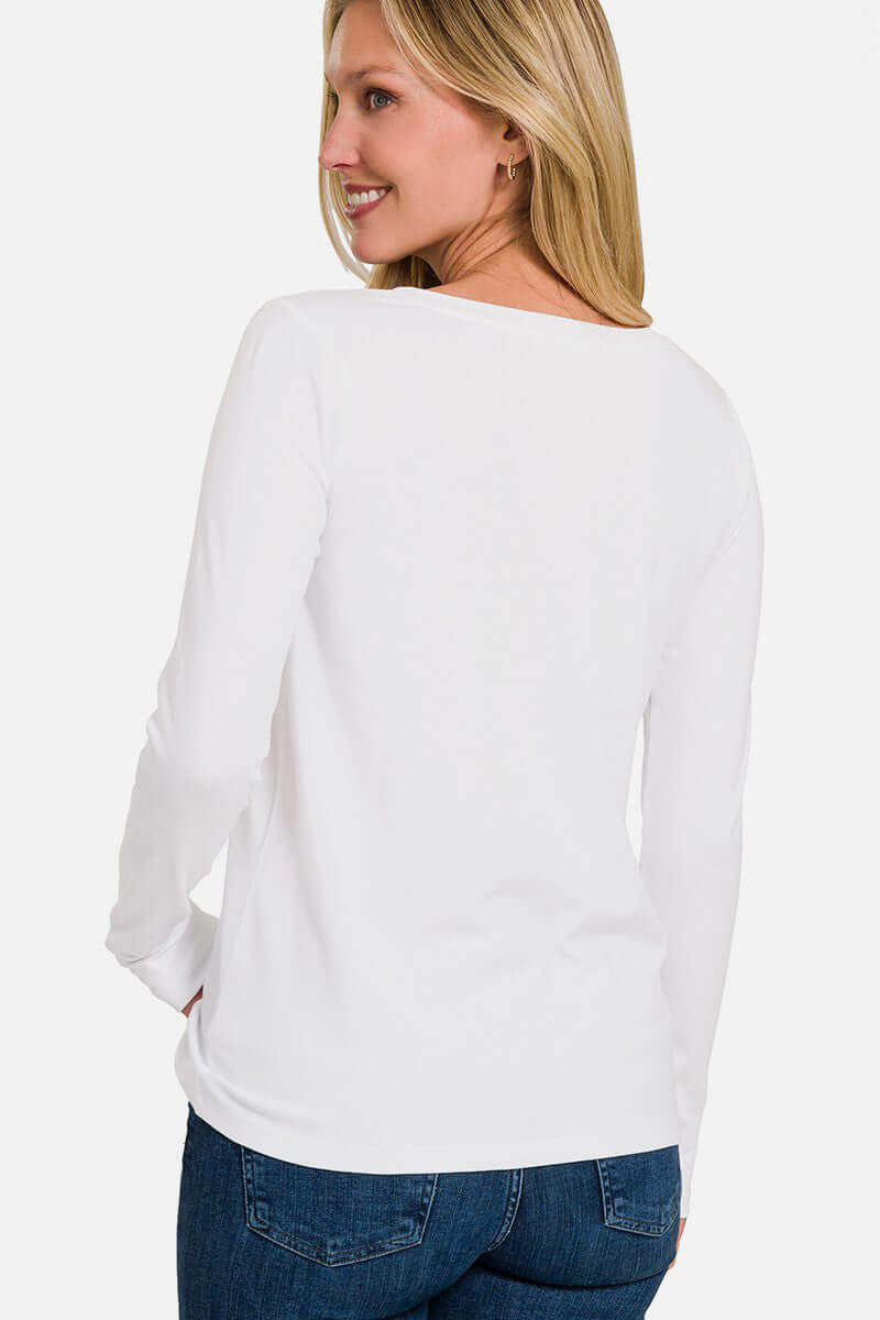 Woman wearing white full size V-neck long sleeve T-shirt with jeans, showcasing the shirt's fit and style from the back.