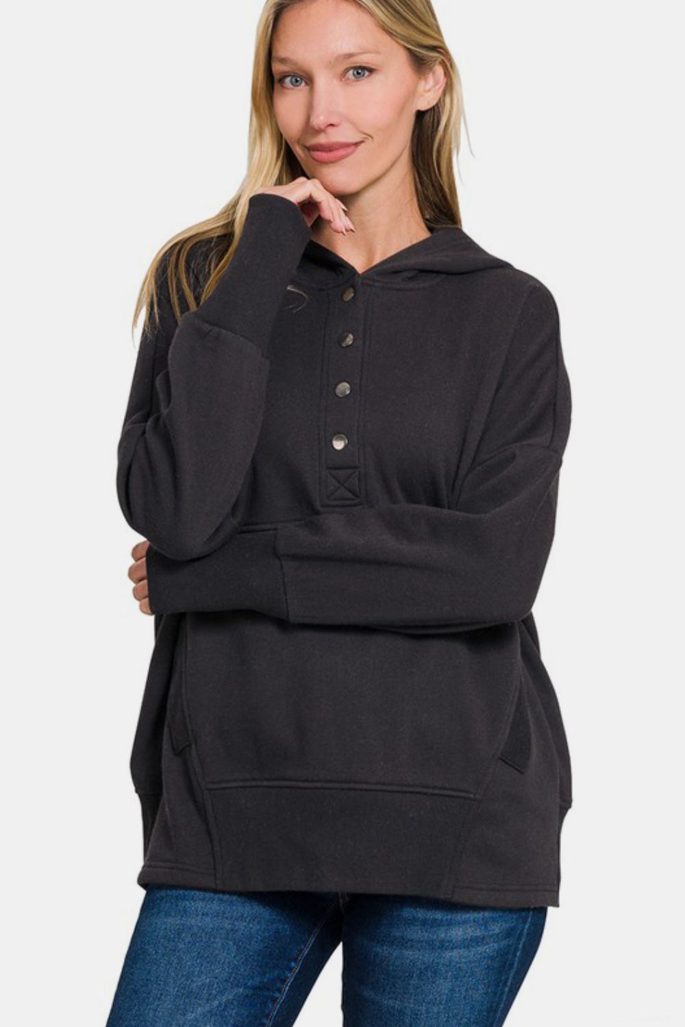 Woman wearing Zenana half snap long sleeve black hoodie with kangaroo pocket and ribbed details, casual and sporty style.