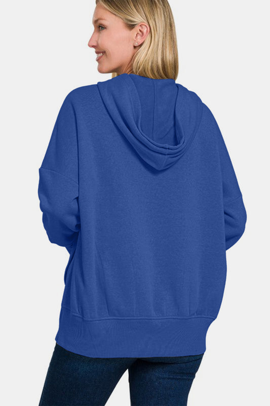 Woman wearing navy half snap long sleeve hoodie with kangaroo pocket, casual style, ribbed design, slightly stretchy fabric