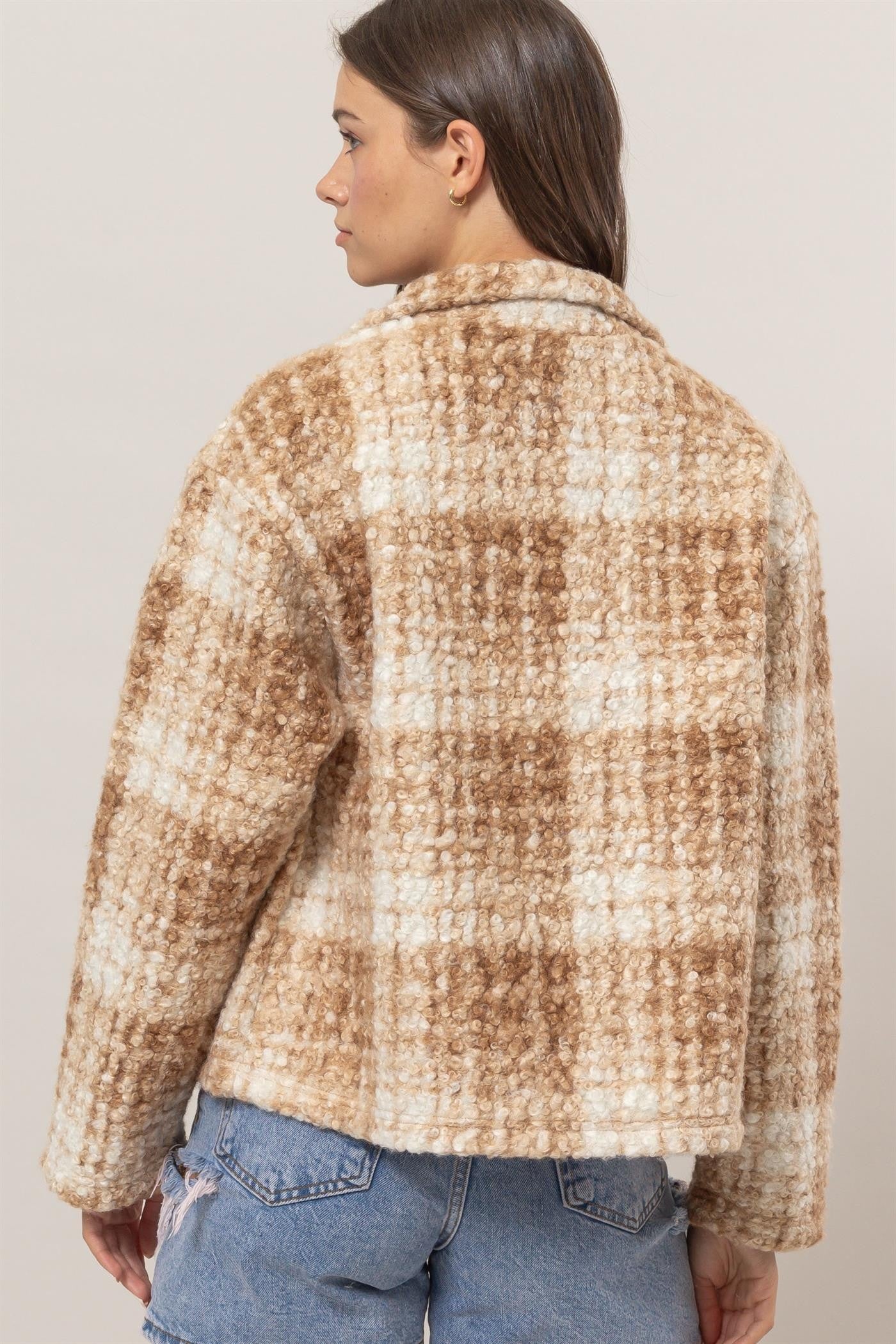 Woman wearing a taupe plaid collared neck boucle jacket with pockets, made from 100% polyester, shown from the back.