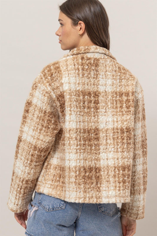 Woman wearing a taupe plaid collared neck boucle jacket with pockets, made from 100% polyester, shown from the back.