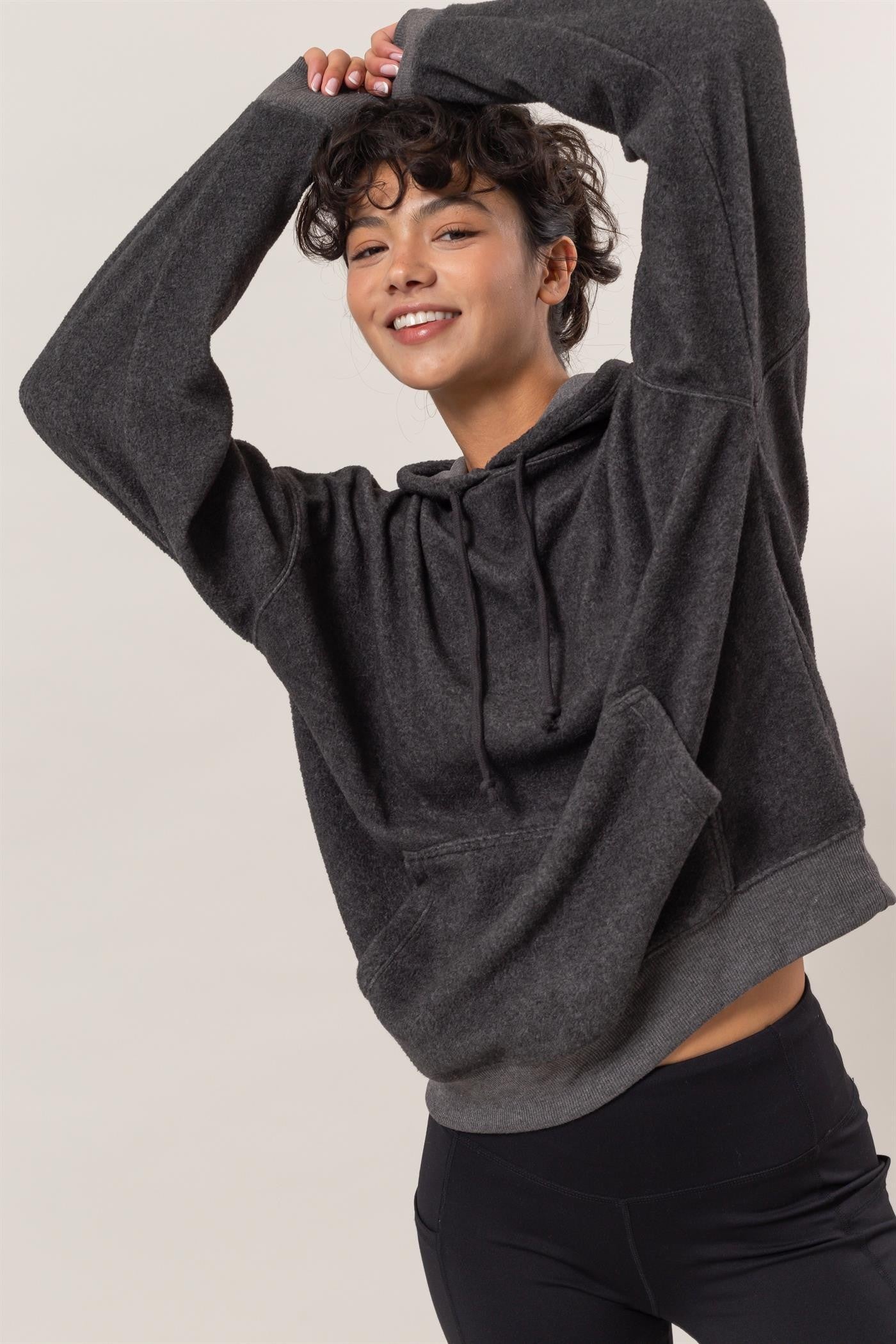 Charcoal brushed long sleeve hoodie with kangaroo pocket, featuring a drawstring and slightly stretchy material.