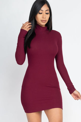 Woman wearing a burgundy ribbed mock neck bodycon mini dress made of polyester and spandex with high stretch rib knit fabric.