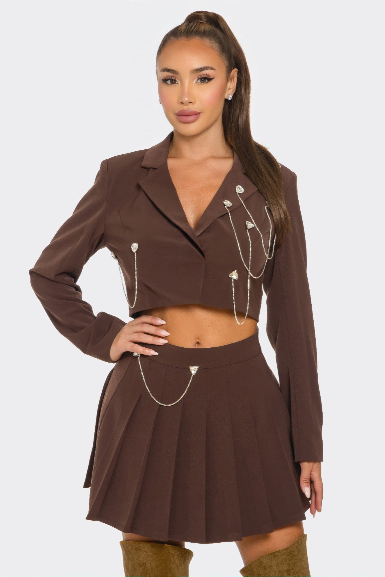 Brown sparkle pleated skirt set with chain details and rhinestones, tailored fit, double-lined for style and comfort.