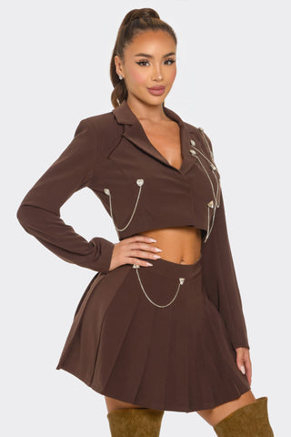 Brown sparkle pleated skirt set with chain details and rhinestones, tailored fit for a stylish look.