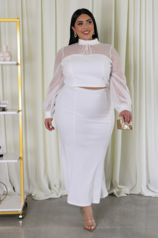 Woman wearing white Curvy Glam Stretch Skirt Set with mock neckline, mesh accents, and long sleeves, showcasing elegant style.