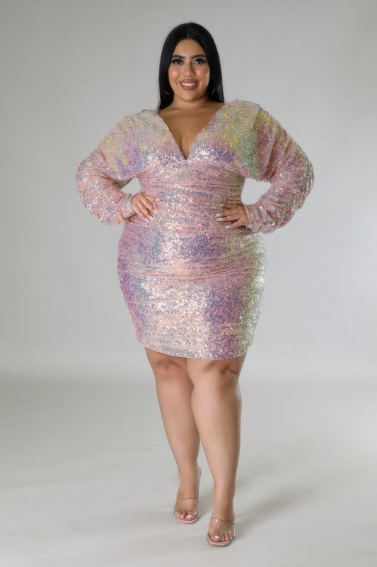 Glam Doll blush pink sequin dress with long ruched sleeves and V-neck, perfect for curvy figures. Available in 1XL, 2XL, 3XL.