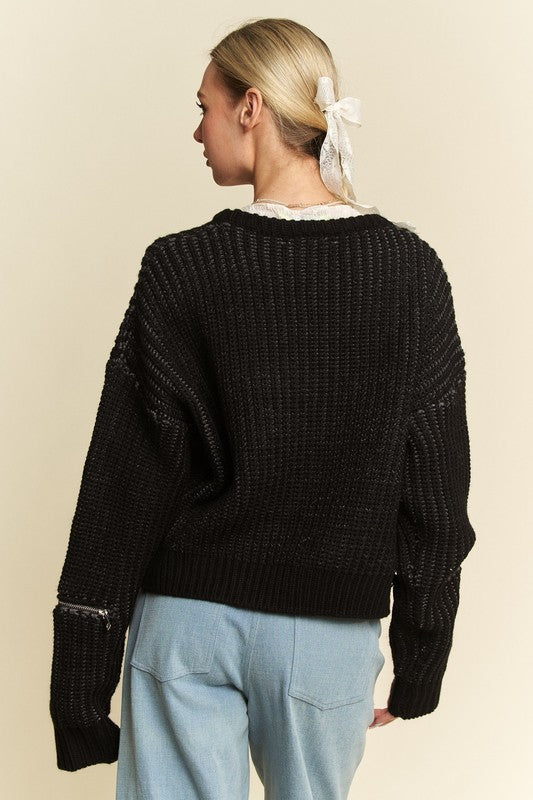 Back view of a black contrast heart dropped shoulder sweater with ribbed texture and no stretch, made of 55% acrylic and 45% cotton.