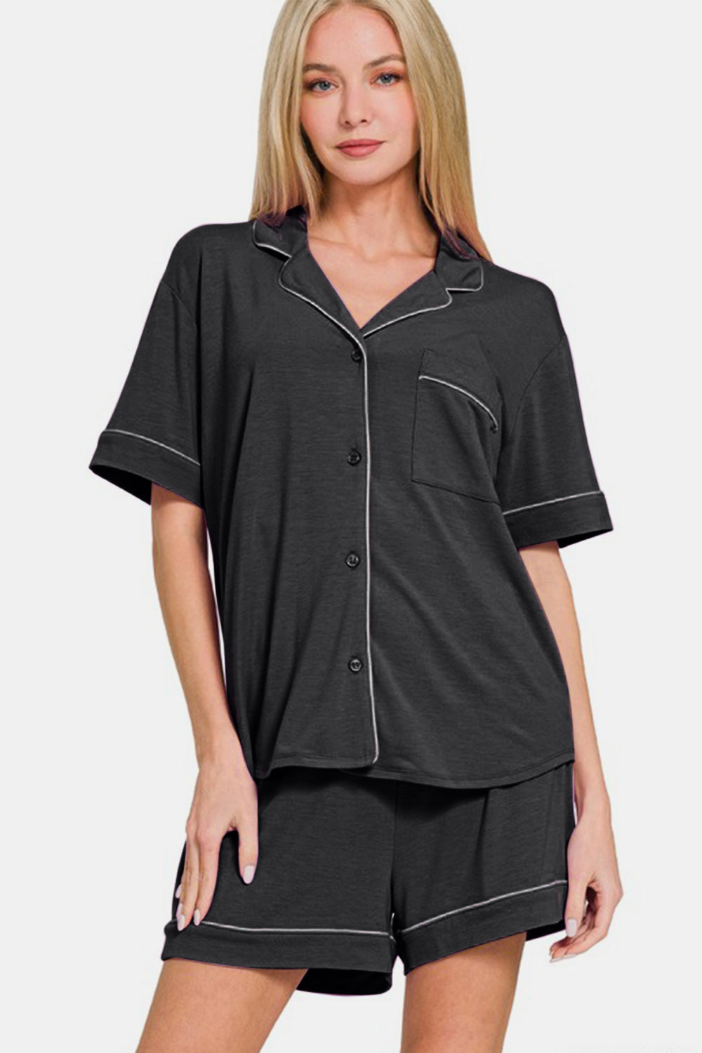 Woman wearing black button-down short sleeve top and shorts lounge set with pocket, slightly stretchy material blend.