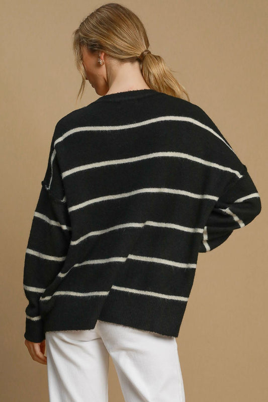 Woman wearing a wool blend striped round neck sweater, featuring basic style and ribbed, slightly stretchy fabric in black and white.