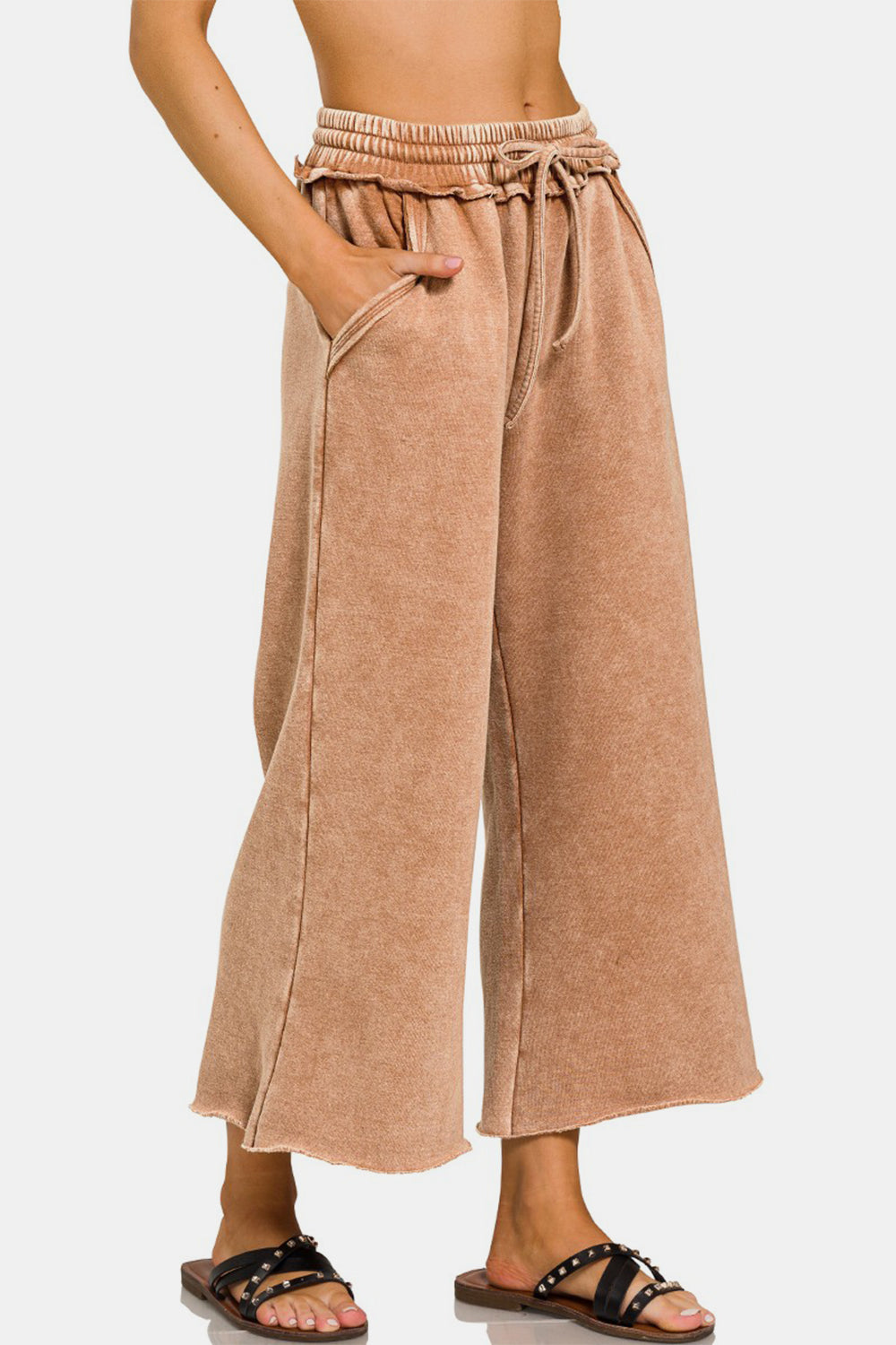 Acid wash fleece wide leg pants with ruched waistband and pockets, made from cotton and polyester blend.