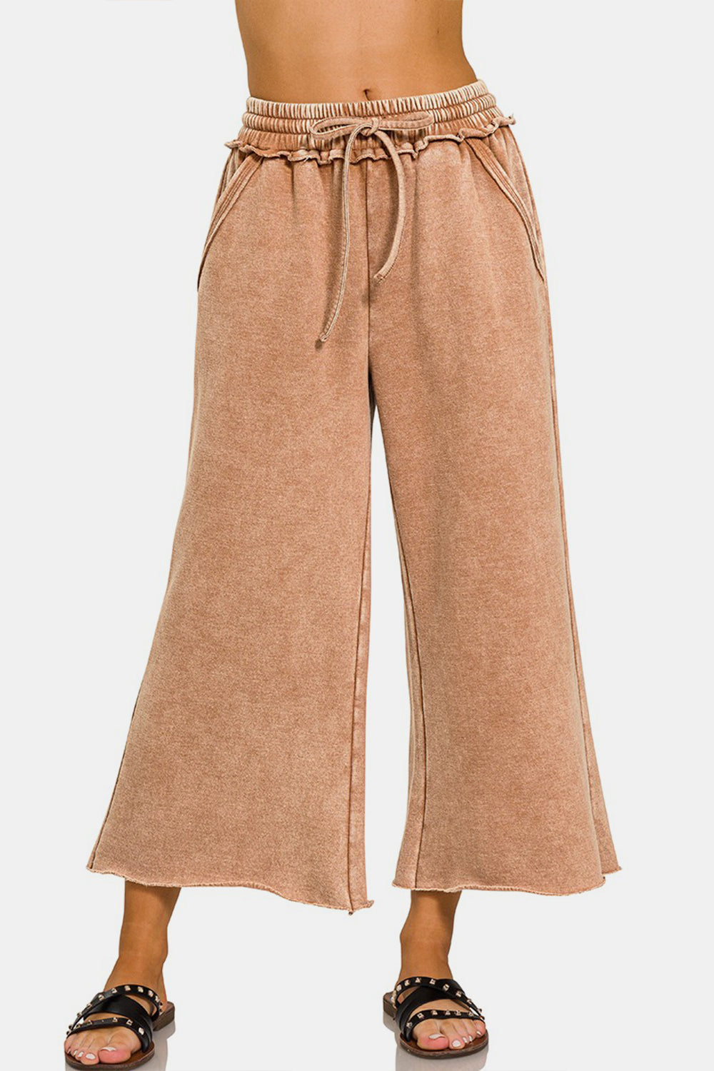 Acid wash fleece wide leg pants with ruched waistband and pockets, made of 60% cotton and 40% polyester, shown on model.