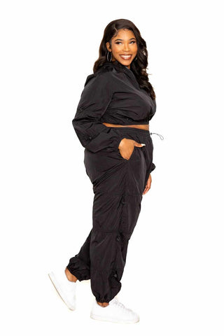 Woman wearing black Active Zip Up Set with Cord Lock Detail, available in plus sizes.