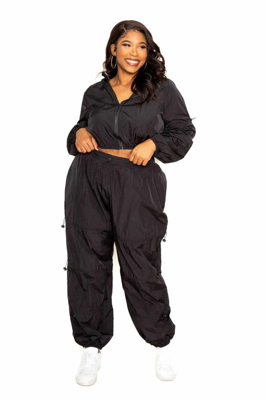 Plus size model wearing black Active Zip Up Set with Cord Lock Detail, showing comfort fit with polyester spandex blend.