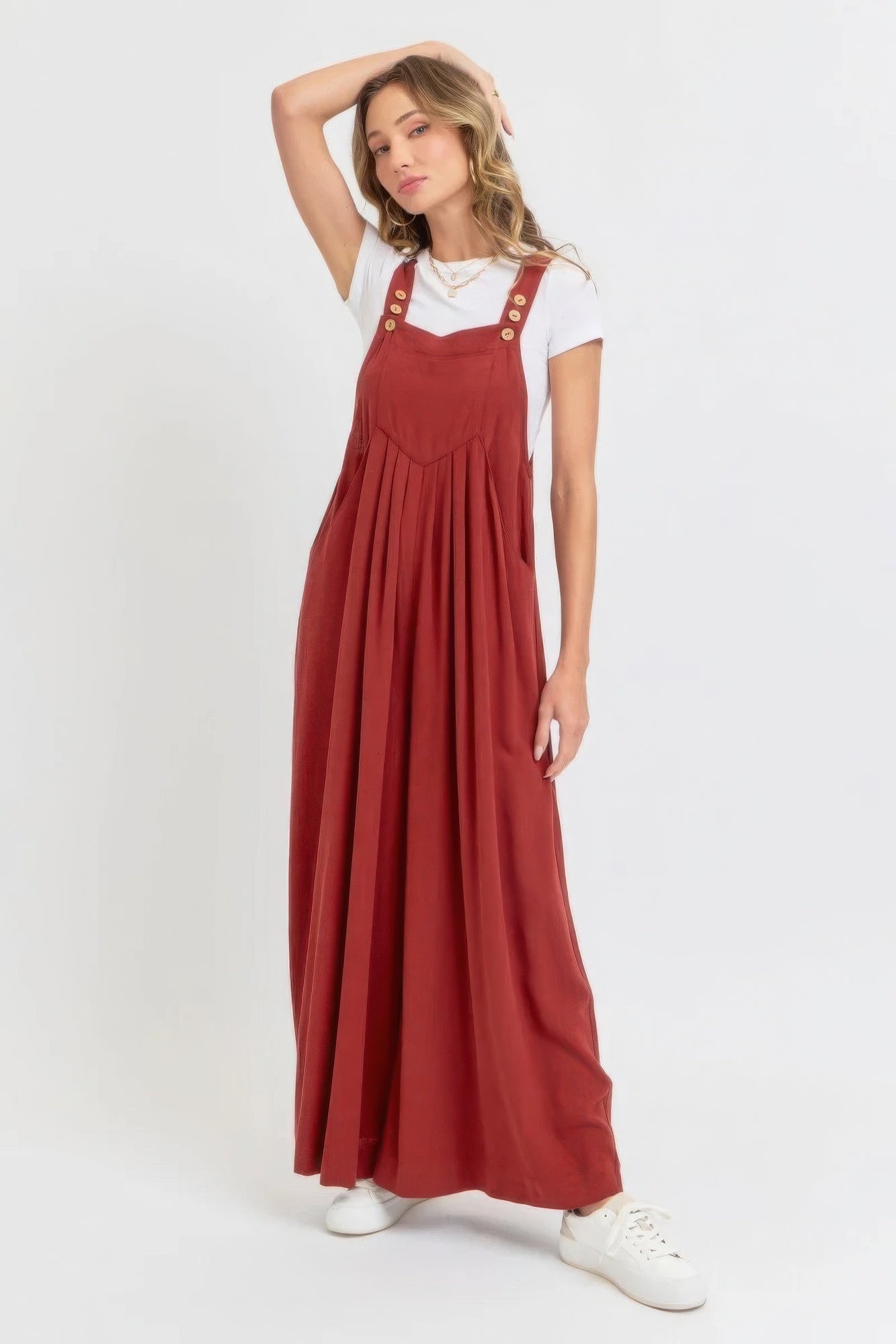 Woman wearing adjustable strap overall wide leg jumpsuit in red, perfect for a chic and relaxed look, ideal for warm weather.