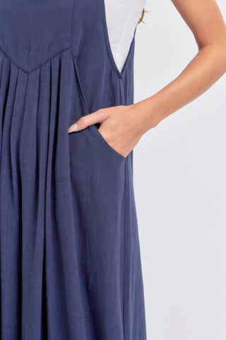 Adjustable strap navy wide leg jumpsuit with side pocket, chic and comfortable blend of rayon and linen, perfect for warm-weather style.