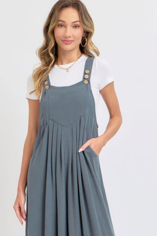 Woman wearing adjustable strap wide leg jumpsuit in a chic, slouchy silhouette, ideal for a stylish and comfortable look