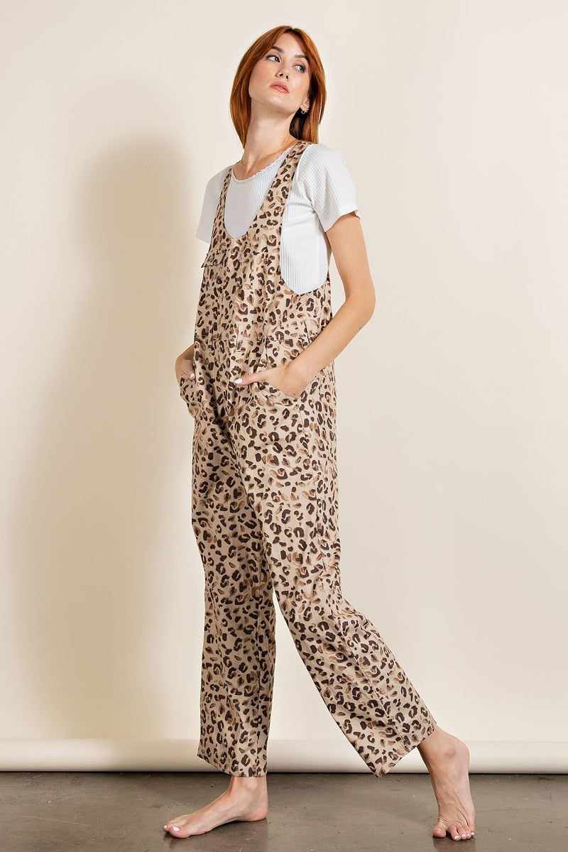 Leopard print jumpsuit with relaxed fit, unisex neckline, chest pockets, racer back, and zip fly in 100% cotton khaki fabric.