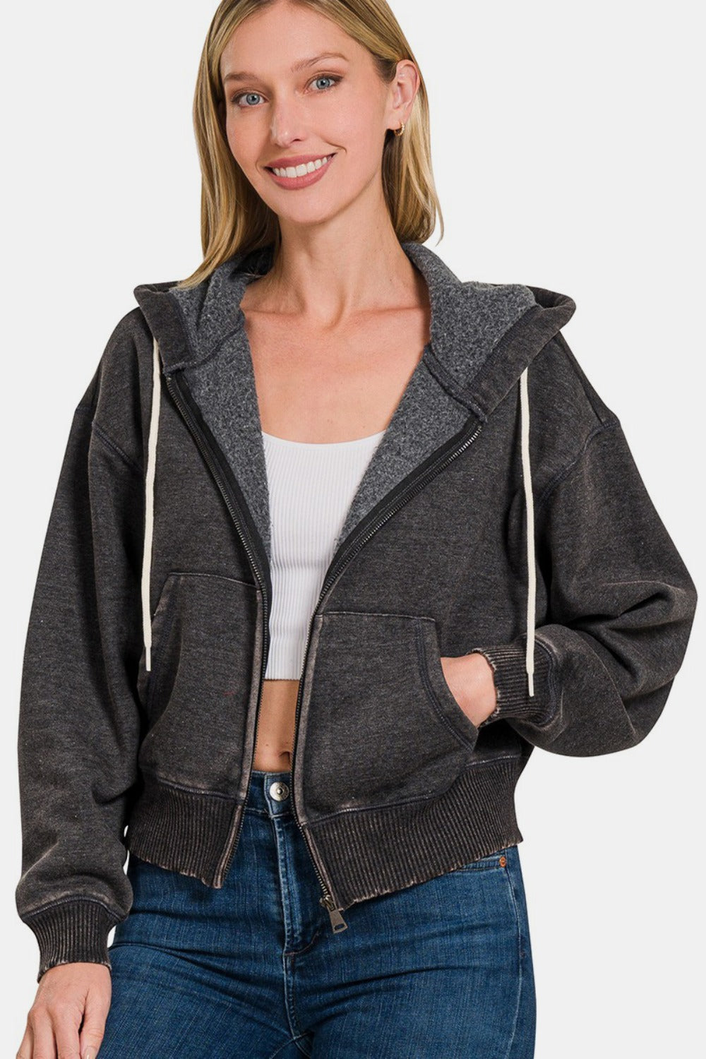 Woman wearing Zenana acid wash fleece zip-up cropped hoodie with retro style.