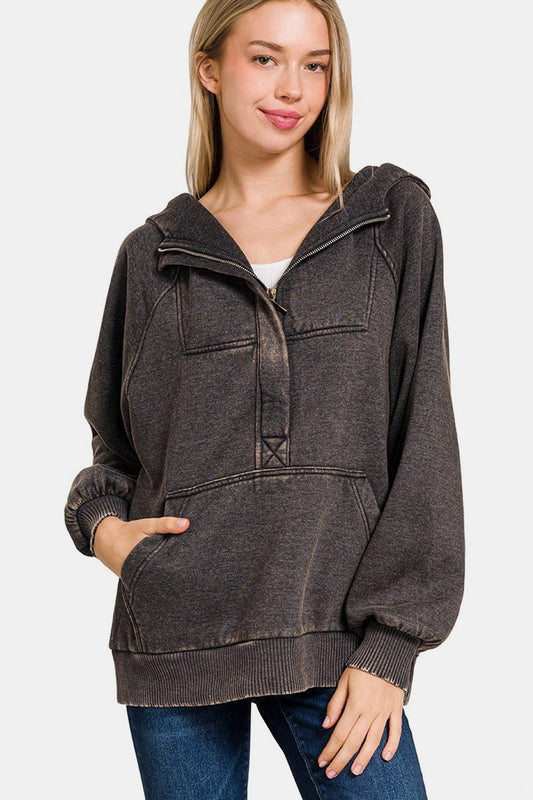 Woman wearing ash black acid wash fleece kangaroo hoodie, featuring a pocket and no stretch, made of 60% cotton and 40% polyester.