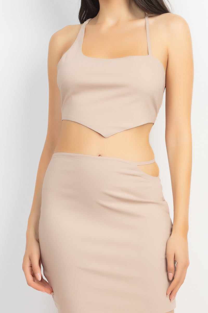 Light Taupe asymmetrical cross back top and skirt set with high waist and mini length, featuring side cutout and drawstring closure.