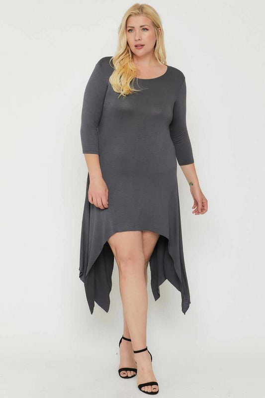 Asymmetrical raw edge hem dress in charcoal with three-quarter sleeves, made of 94% rayon and 6% spandex, shown in plus size model.