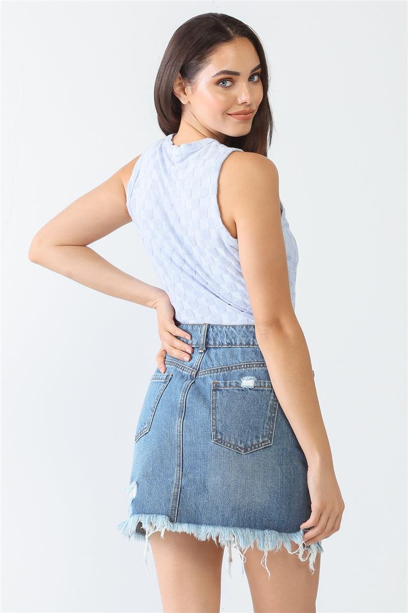 Woman wearing baby blue chess sleeveless bodysuit and denim skirt, showcasing back design in casual lifestyle setting