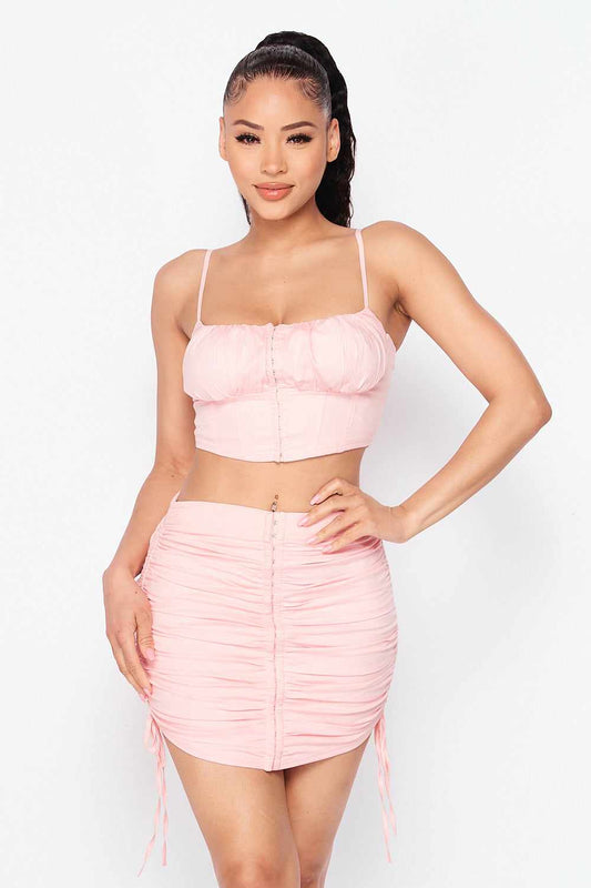 Baby girl pink crop top and skirt set with adjustable drawstring, perfect for comfort and style. Made with cotton, nylon, and spandex.