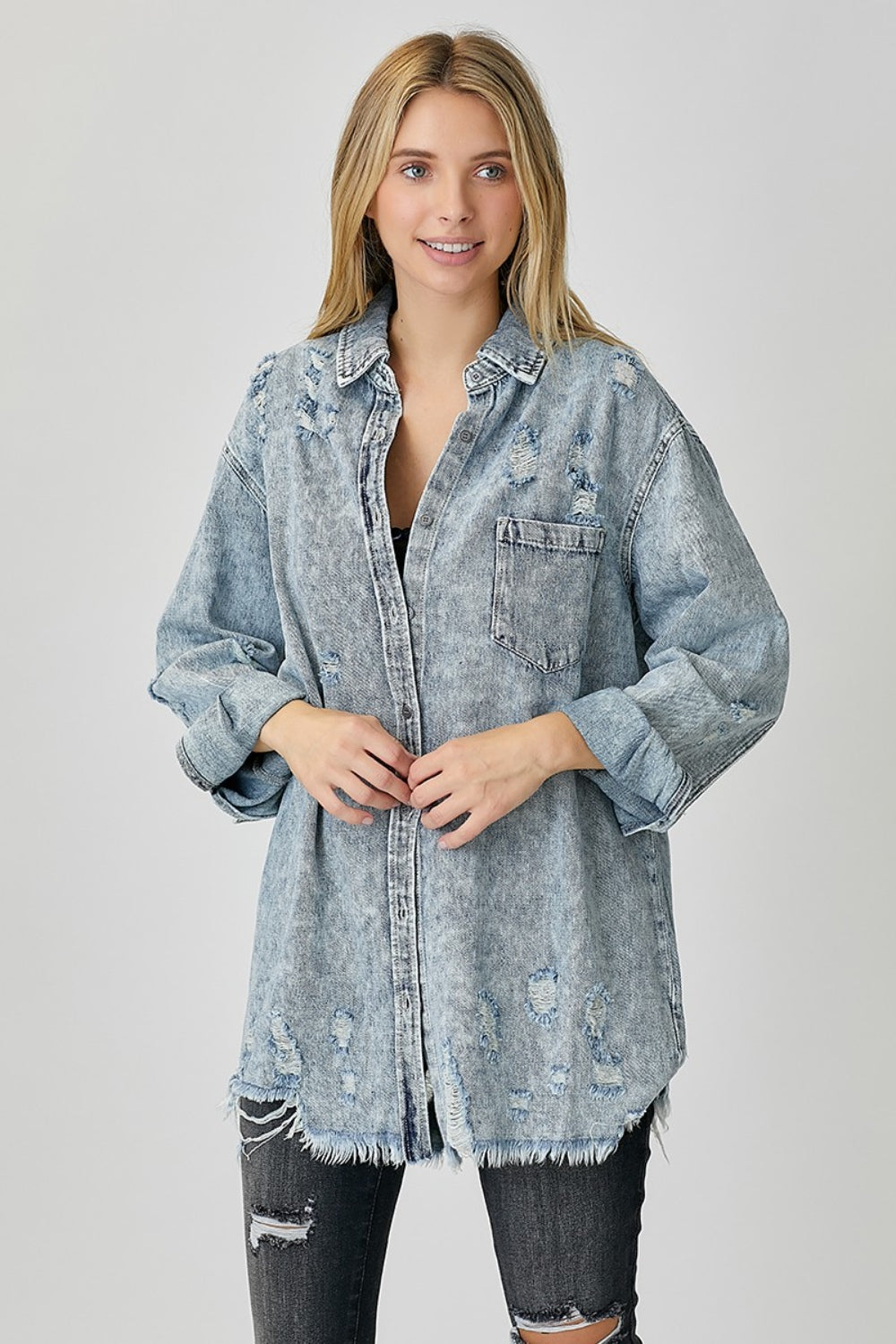 Woman wearing a Bae Distressed Raw Hem Denim Shirt made of 100% cotton with washed texture and no stretch.