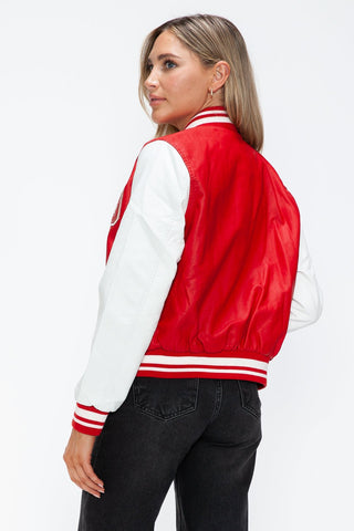Woman wearing red and white PU leather contrast snap down bomber jacket, showing back detail.