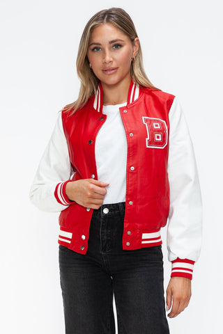 Woman wearing a red and white baseball PU leather bomber jacket with snap-down front and letter "B" detail.