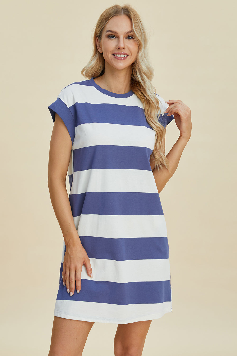 Woman wearing Basic Bae Striped Round Neck Cap Sleeve Mini Dress in blue and white, showcasing stylish casual fashion.