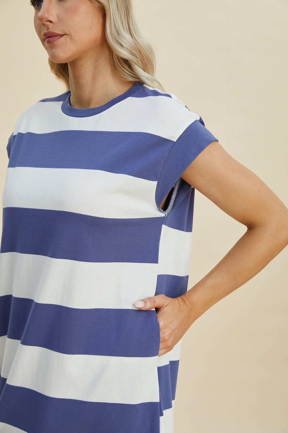 Woman wearing a Basic Bae striped round neck cap sleeve mini dress in blue and white, showcasing casual chic style.