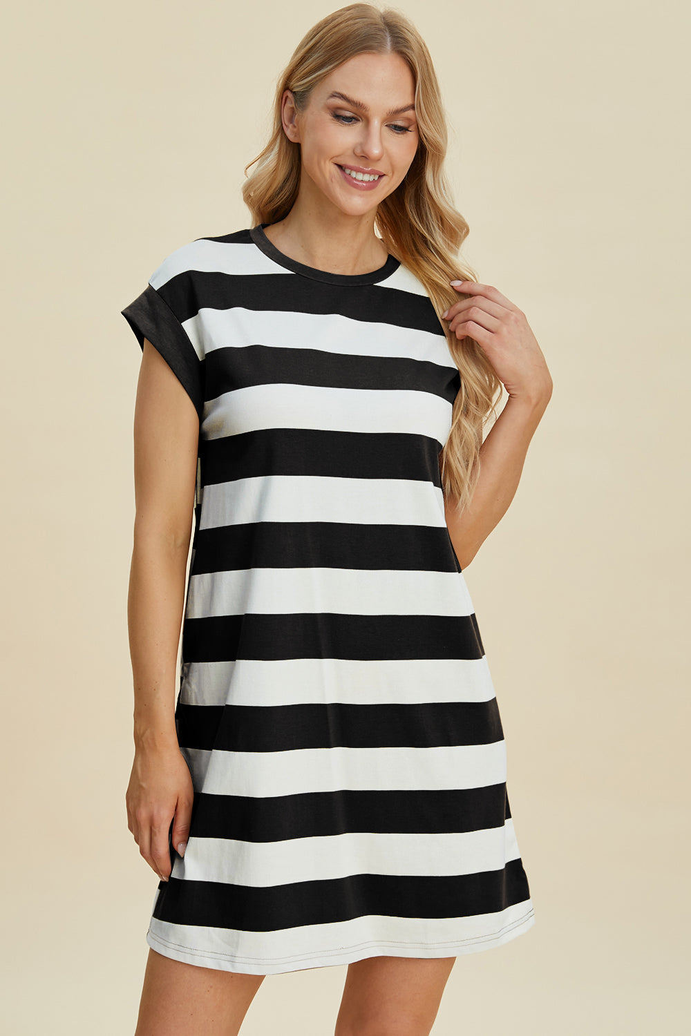 Woman wearing Basic Bae striped round neck cap sleeve mini dress in black and white, featuring a basic style with slight stretch.