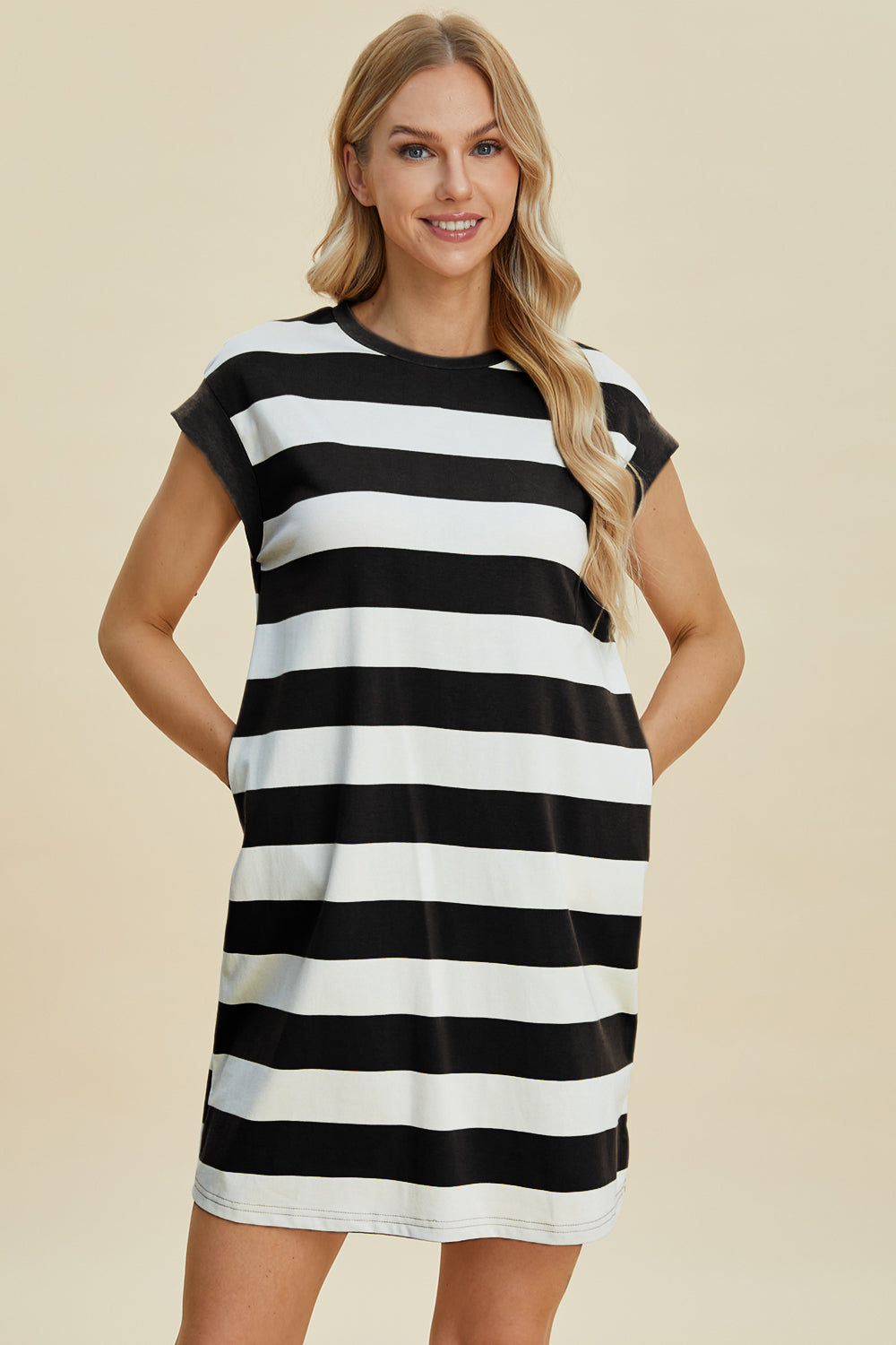 Woman wearing Basic Bae striped round neck cap sleeve mini dress, black and white stripes, slightly stretchy, 50% polyester cotton blend.