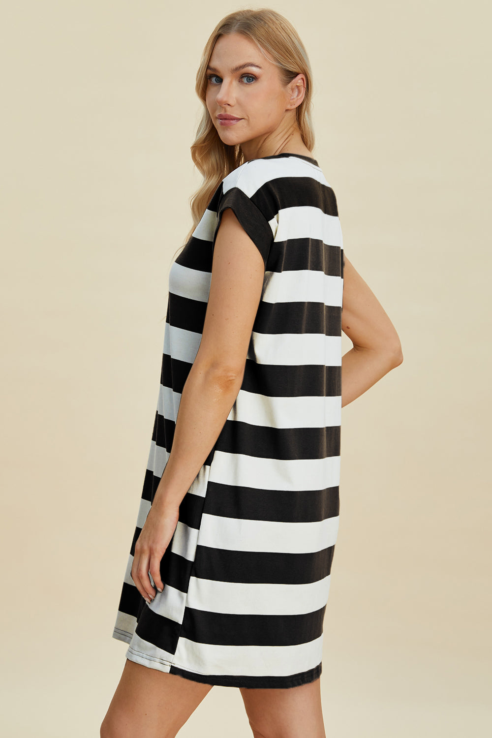 Woman wearing Basic Bae striped round neck cap sleeve mini dress, black and white, slightly stretchy fabric.