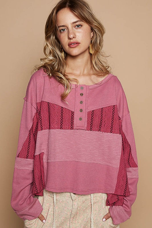 Woman wearing a Cerise Half Button Color Block Drop Shoulder Knit Top with waffle-knit texture and eyelet details.