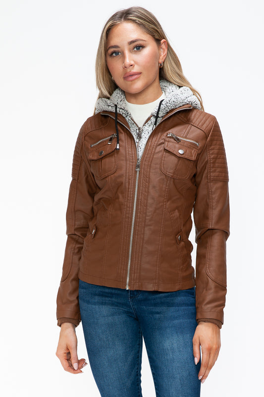 Removable faux layered multi-pocket jacket with fuzzy hood and brown pleather material worn by woman.