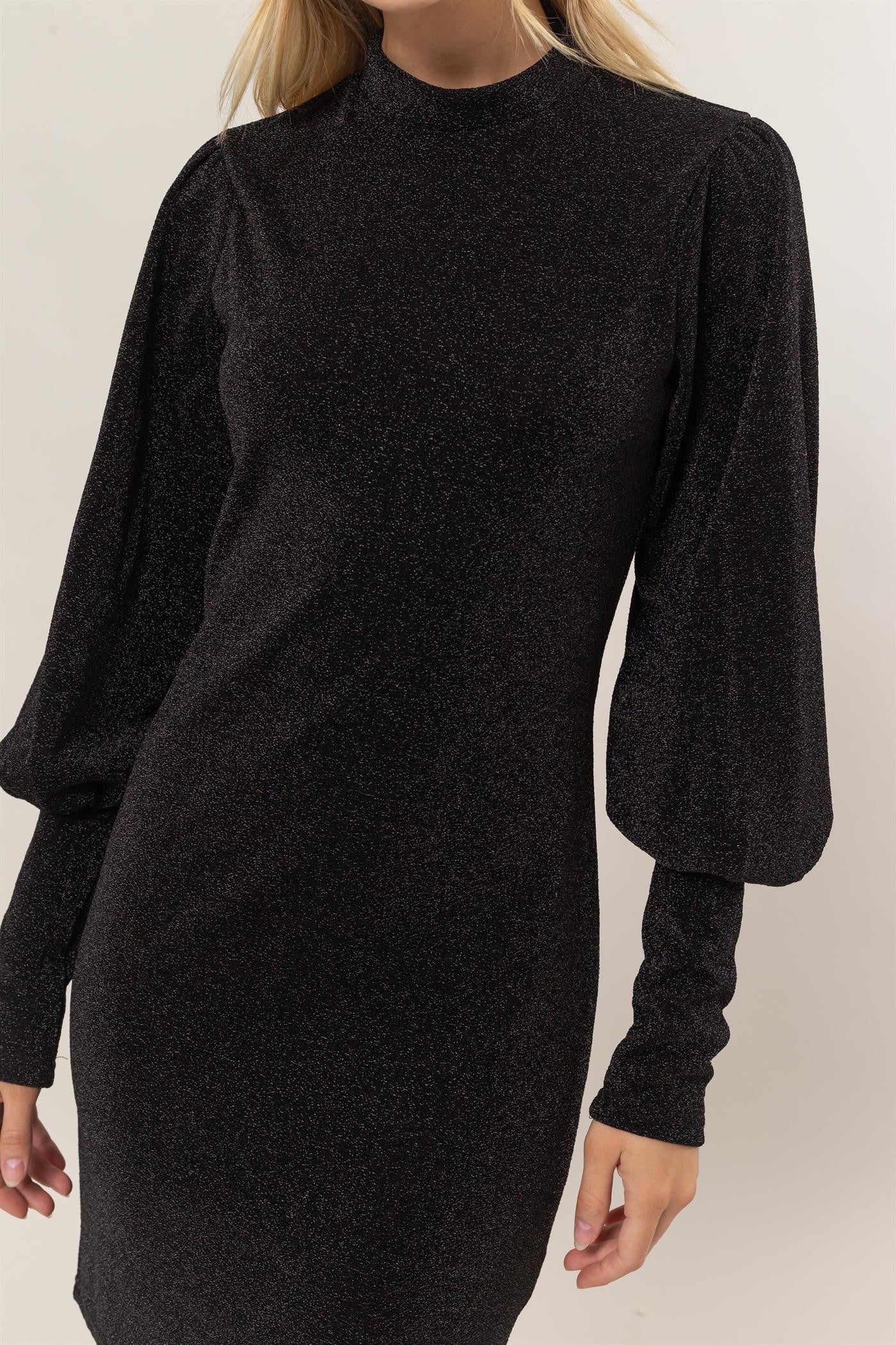 Black glitter mock neck long sleeve mini dress with slightly stretchy fabric, featuring opaque material and elegant design.