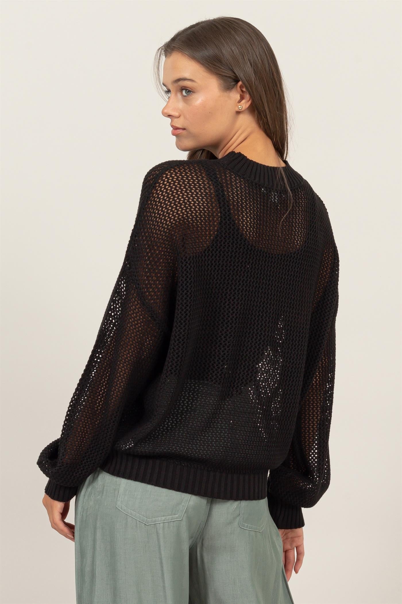 Woman wearing HYFVE black star pattern openwork knit cover-up, showing back view and intricate design.