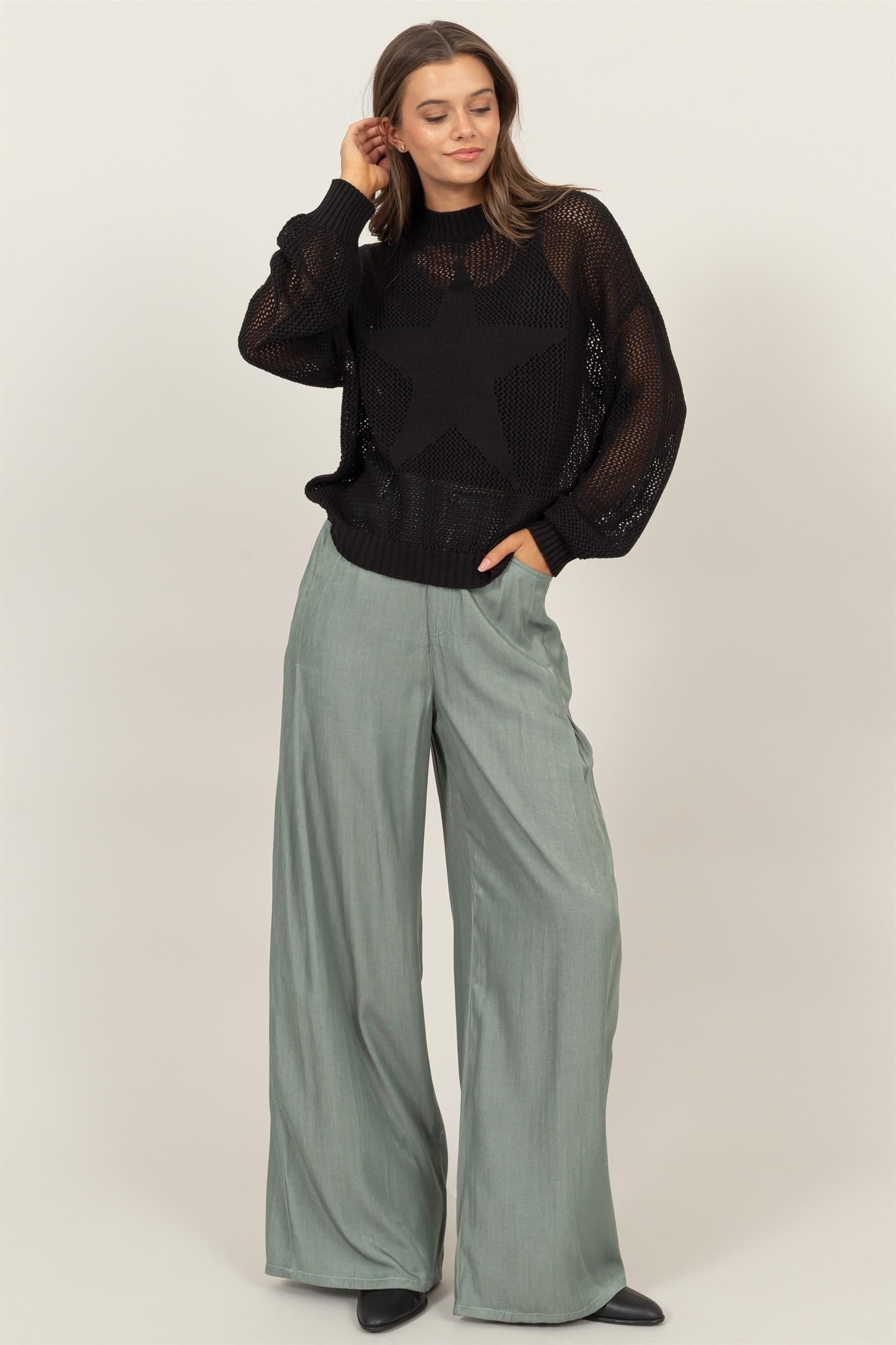 Woman wearing HYFVE Star Pattern Openwork Knit Cover Up with wide-leg pants, showcasing elegant and versatile style.