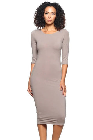 Woman wearing taupe midi bodycon dress with 3/4 sleeves and scoop back, made of stretch knit fabric, standing against a white background.