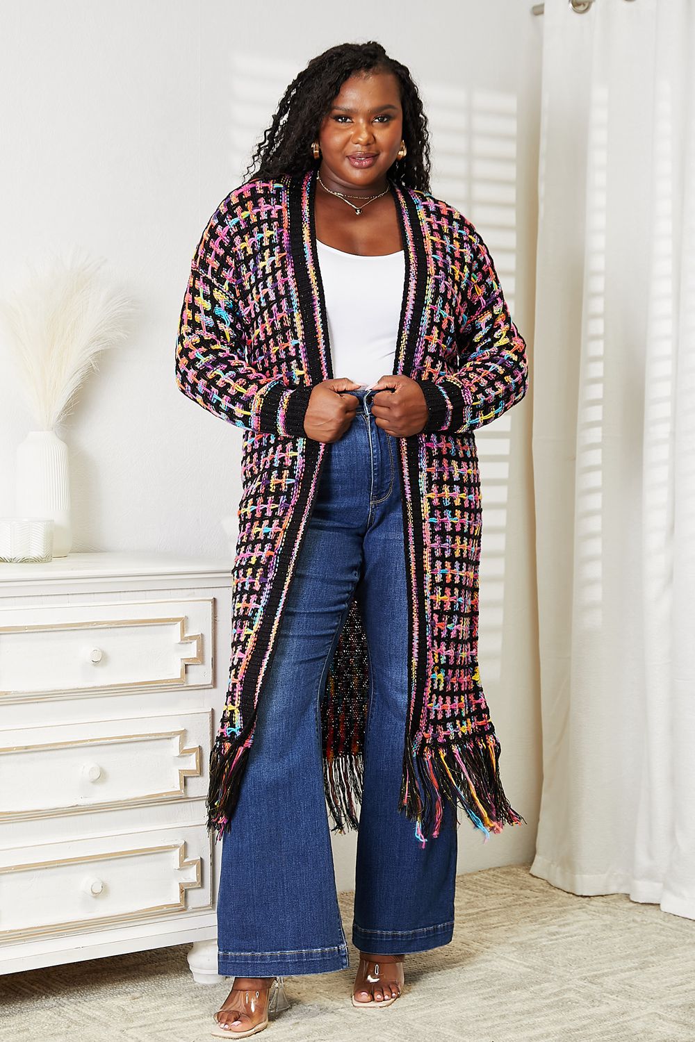 Bohemian chic multicolored open front fringe hem cardigan, versatile and trendy, modeled over casual denim and white top.