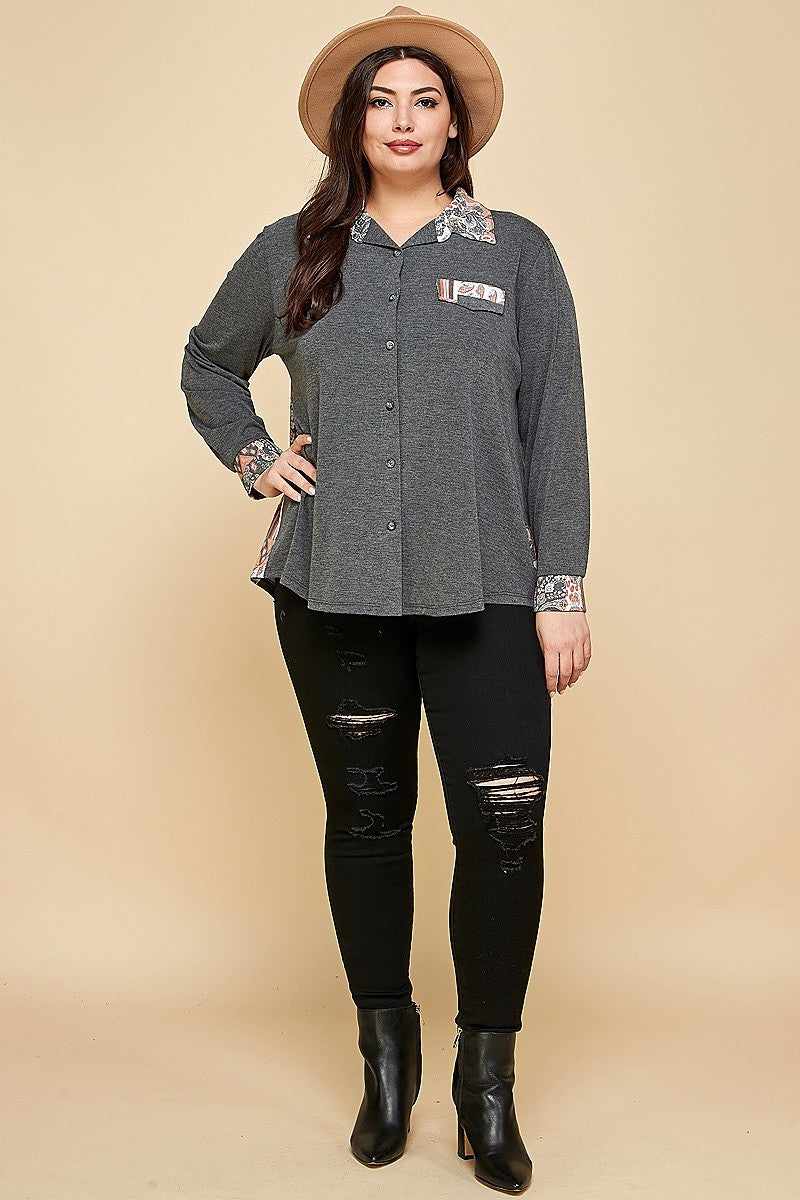 Plus size woman wearing charcoal patchwork button-up shirt with hat and black jeans, showcasing casual fashion style.