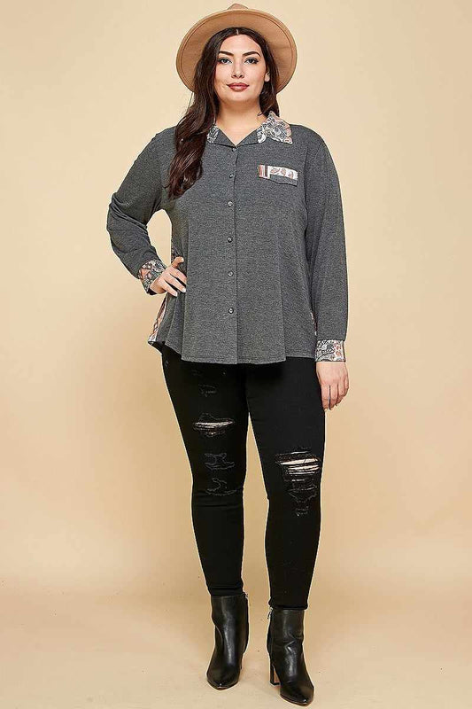 Plus size woman wearing charcoal patchwork button-up shirt with hat and black jeans, showcasing casual fashion style.