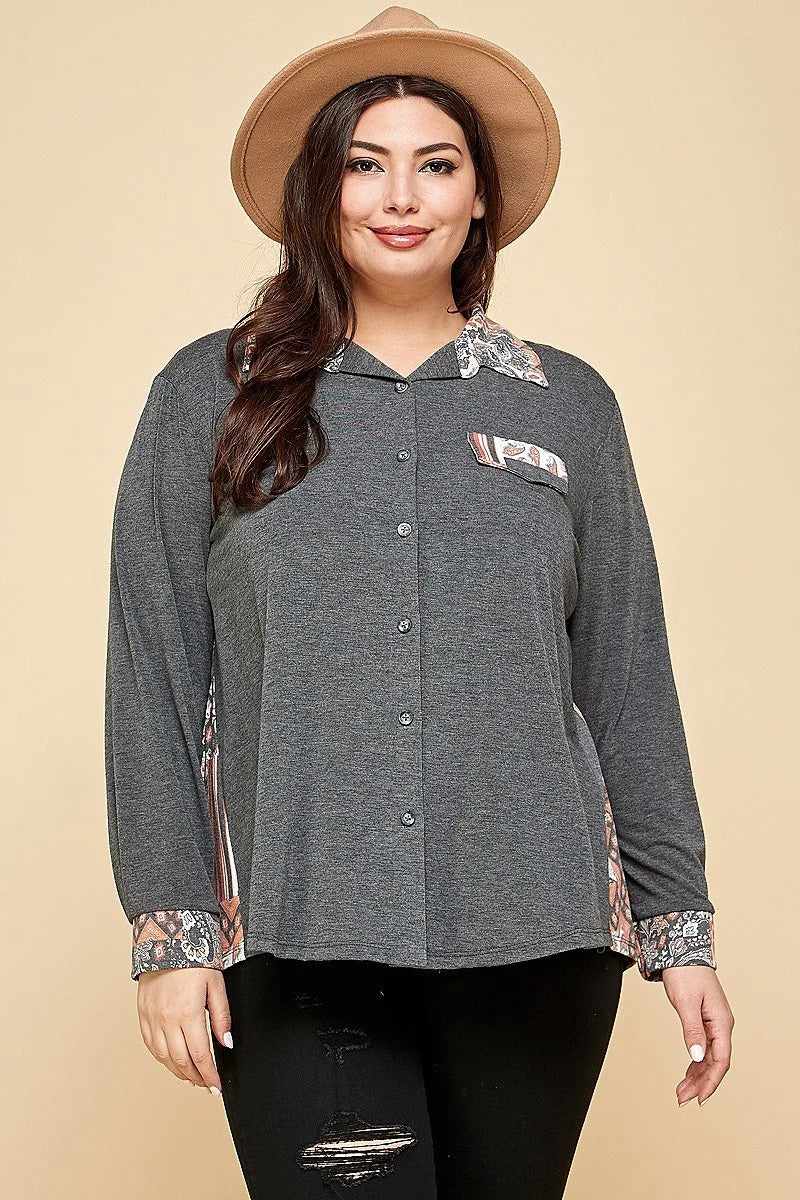 Plus size charcoal button-up shirt with patchwork detail and spread collar, worn by woman with hat.