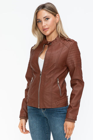Woman wearing Brandy PU Leather Biker Jacket with side zip pockets, showcasing basic style and normal thickness.