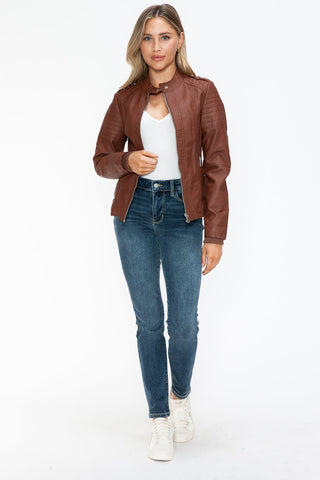 Woman wearing Brandy PU Leather Biker Jacket with side zip pockets, casual style pairing with jeans and white top.