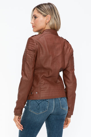 Woman wearing brown Brandy PU Leather Biker Jacket with side zip pockets and quilted sleeves, back view displaying pleather texture.